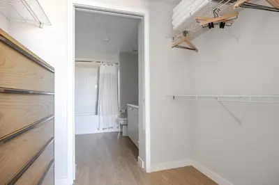 a room with a white wall and a hallway with a window at Blueground Downtown elevator nr parks LAX-1250 in Los Angeles