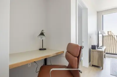 a desk and a chair in a room with a window at Blueground Downtown elevator nr parks LAX-1250 in Los Angeles