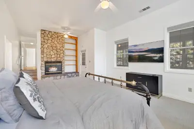 a bedroom with a bed and a fireplace at Castlewood Retreat at Big Bear Central Modern Family Chalet in Big Bear Lake