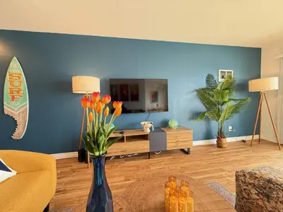 a living room with a vase of flowers on a table at Oceanfront 1 Bed 1 Bath, Parking, Amazing View 132 in Redondo Beach
