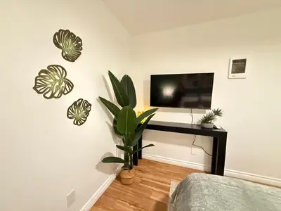 a room with a tv and a plant on a wall at Oceanfront 1 Bed 1 Bath, Parking, Amazing View 132 in Redondo Beach