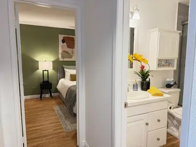 a bathroom with a bed and a sink and a mirror at Oceanfront 1 Bed 1 Bath, Parking, Amazing View 132 in Redondo Beach