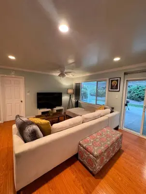 a living room with two couches and a tv at Suburban oasis home in Monterey Park