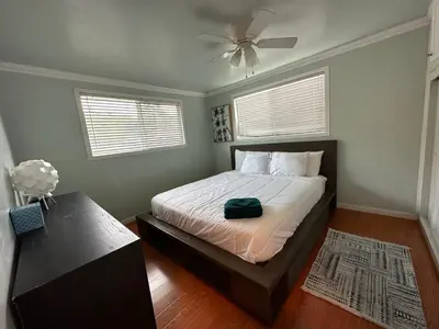 a bedroom with a bed and a ceiling fan at Suburban oasis home in Monterey Park