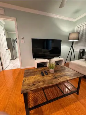 a living room with a coffee table and a flat screen tv at Suburban oasis home in Monterey Park