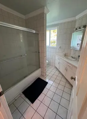 a bathroom with a shower and a tub and a sink at Suburban oasis home in Monterey Park
