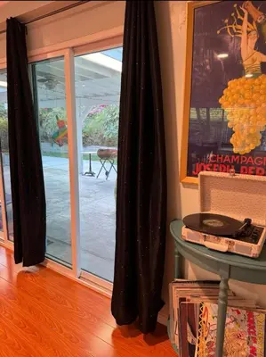 a room with a sliding glass door and a table at Suburban oasis home in Monterey Park