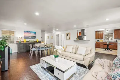 a living room with a couch and a table at Spacious Retreat w Large Kitchen & Outdoor Patio in Pasadena