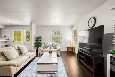 a living room with a couch and a tv at Spacious Retreat w Large Kitchen & Outdoor Patio in Pasadena