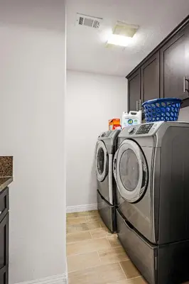 a kitchen with a washing machine in a room at Spacious Retreat w Large Kitchen & Outdoor Patio in Pasadena