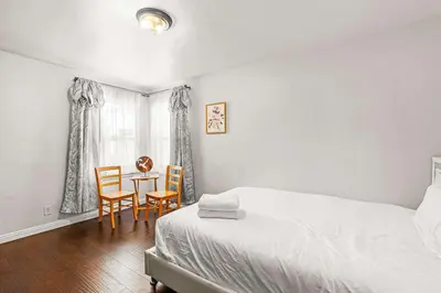 a bedroom with a bed and a table and chairs at Spacious Retreat w Large Kitchen & Outdoor Patio in Pasadena