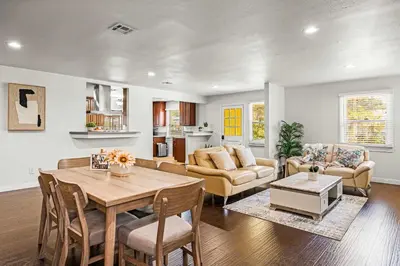 a kitchen and living room with a table and chairs at Spacious Retreat w Large Kitchen & Outdoor Patio in Pasadena