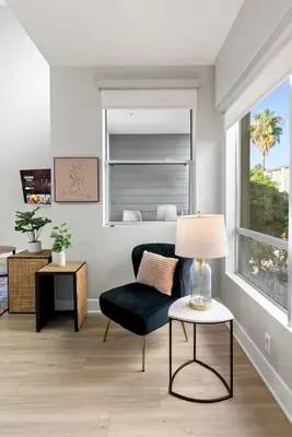 a living room with a chair and a table at Spacious Loft- Hollywood Free Pool, Parking, Gym in Los Angeles