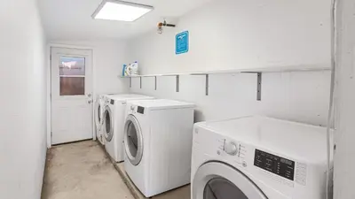 a laundry room with two washing machines and a window at 2 Units in Prime Hollywood Location Chic Renovated 1BDRs w Patio AvantStay in Los Angeles