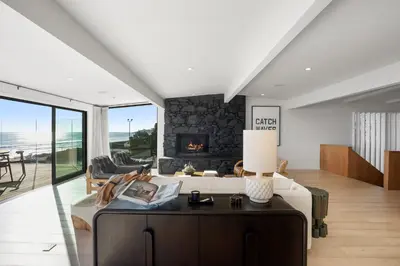 a living room with a bed and a fireplace at The Surf Lodge Villa in Malibu