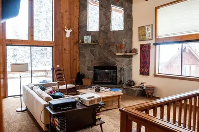 a living room with a couch and a fireplace at Blue Jay's Nest Sequoia Cabin in Ponderosa, CA in Ponderosa