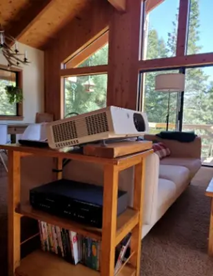 a computer on a table in a living room at Blue Jay's Nest Sequoia Cabin in Ponderosa, CA in Ponderosa