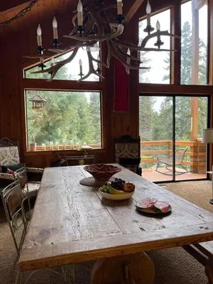 a wooden table with a bowl of food on it at Blue Jay's Nest Sequoia Cabin in Ponderosa, CA in Ponderosa