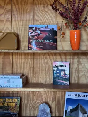 a book shelf with books and a vase on it at A-Frame with Carousel Fireplace in Running Springs