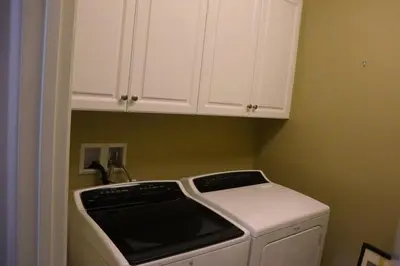 a kitchen with a stove and white cabinets at Pretty Relaxed Me in Brea