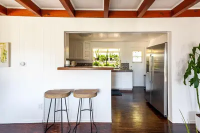 a kitchen with two bar stools and a counter at Tranquil and Secluded Retreat in Topanga Canyon in Topanga