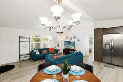 a living room with a blue couch and a table at Disney Beaches Close Fire Pit Stadiums in Norwalk