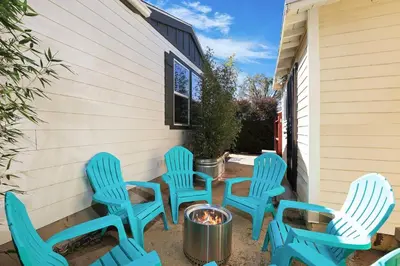 a group of blue chairs sitting next to a building at Disney Beaches Close Fire Pit Stadiums in Norwalk