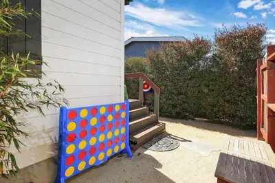 a blue and orange board next to a house at Disney Beaches Close Fire Pit Stadiums in Norwalk