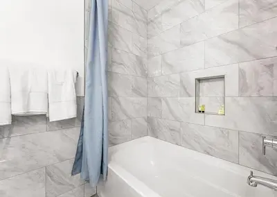 a bathroom with a white tub and a shower at Love & LuxuryHeart Shaped Pool Paradise in Los Angeles