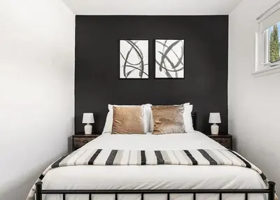 a bedroom with a large bed with two windows at Love & LuxuryHeart Shaped Pool Paradise in Los Angeles