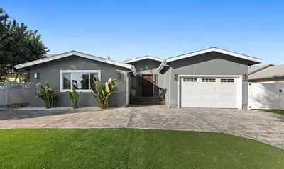 a large gray house with a white garage at Love & LuxuryHeart Shaped Pool Paradise in Los Angeles
