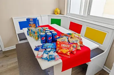 a table with chips and other snacks on it at Princess Palace by OC Adventure Homes in Anaheim