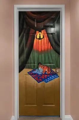 a door with a painting of a man sitting on a bed at Princess Palace by OC Adventure Homes in Anaheim