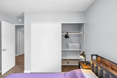 a bedroom with a bed and a white wall at Sunny Simi Valley Valley 4BR 3BR LTR Modern Home Dedicated Work Place High Speed internet in Simi Valley