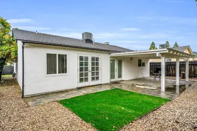 a white house with a lawn in front of it at Sunny Simi Valley Valley 4BR 3BR LTR Modern Home Dedicated Work Place High Speed internet in Simi Valley