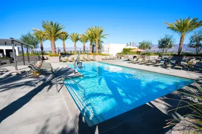 a swimming pool with chaise lounge chairs and palm trees at Heart of North Hollywood 2 bed Apt FREE parking, hot tub, pool, gym in Garnsey