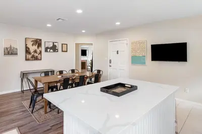 a kitchen and dining room with a table and a tv at Comfy Home Near Sofi Stadium 2 in Los Angeles