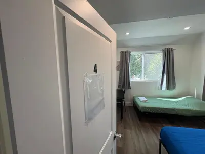 a room with a door with a bed and a window at Blue Central Stay Near USC, BMO Stadium & Downtown LA in Los Angeles