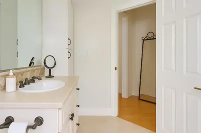 a white bathroom with a sink and a mirror at The Heart Of Hollywood Hills in Los Angeles