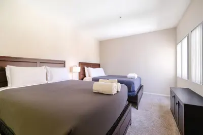 a hotel room with two beds and a window at The Heart Of Hollywood Hills in Los Angeles