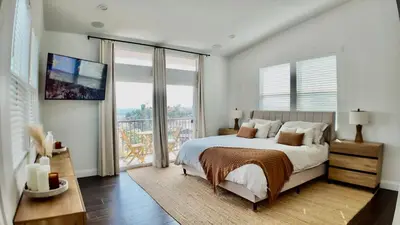 a bedroom with a large bed and a large window at House in the Hills in Los Angeles
