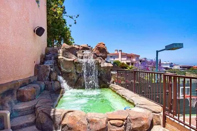 a water fountain in a yard next to a building at House in the Hills in Los Angeles