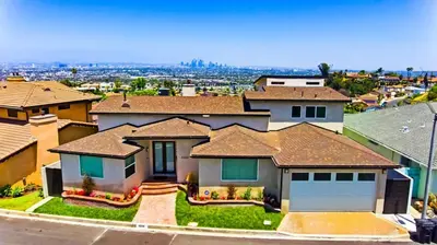 a large house with a garage in a neighborhood at House in the Hills in Los Angeles
