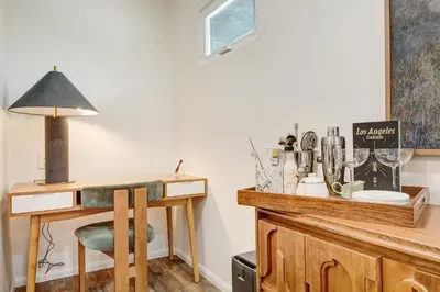 a room with a desk with a chair and a lamp at Peaceful 5-Acre Stay - The Emerald Grove Retreat in La Verne