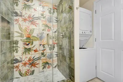 a bathroom with a shower with a floral wallpaper at Peaceful 5-Acre Stay - The Emerald Grove Retreat in La Verne