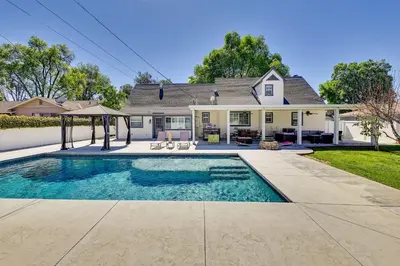 a house with a swimming pool in front of a house at 4 Mi to Dtwn Riverside Gem with Pool and Game Room in Riverside
