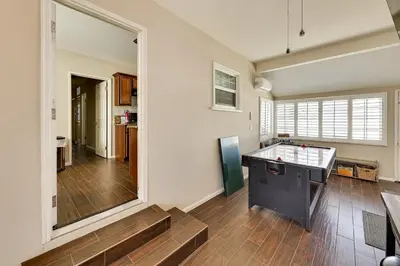 a living room with a table in the middle of a room at 4 Mi to Dtwn Riverside Gem with Pool and Game Room in Riverside