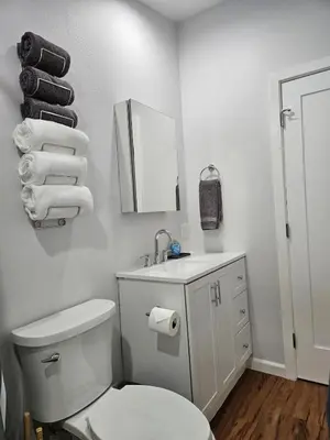 a bathroom with a toilet and a sink and a mirror at Modern 1-bedroom Studio with Full Kitchen and Bath in Santa Clarita