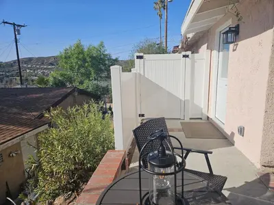 a patio with a table and a chair and a fence at Modern 1-bedroom Studio with Full Kitchen and Bath in Santa Clarita