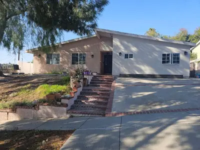 a white building with stairs in front of it at Modern 1-bedroom Studio with Full Kitchen and Bath in Santa Clarita